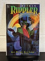 Front cover of Batman Riddler graphic novel showing the Riddler character in green suit and hat with colorful background.
