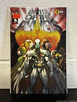 Front cover photo showing comic book with detailed artwork of multiple characters and title.