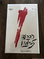 Photo of the Blood Lines #1 comic book in protective sleeve showing cover art, price, and signature by Rob Walton.
