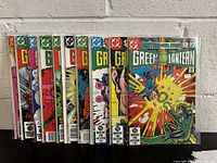 Photo of eleven Green Lantern comic books numbered 159 through 169 with covers visible, all appearing in fine to near mint condition in plastic sleeves.