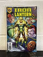 Front cover of Iron Lantern #1 comic book showing main armored character and four faces in background, Amalgam Comics logo visible on top left.