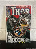 Front cover photo of The Mighty Thor #409 comic book featuring Doctor Doom and Thor inside an hourglass.