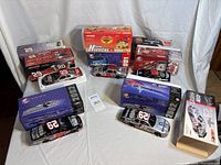 Overview of all five boxed diecast cars with one car displayed