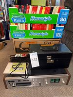 Overall lot showing tape deck, tapes in boxes, storage case