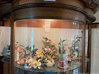 Cabinet shelf with full group of porcelain hummingbird figurines