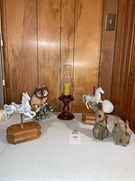 Front view of all figurines and candle holder on table