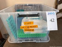 Lot overview showing tumblers and ice trays in bin