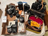 Overview of camera, lenses, flash, binoculars in two trays