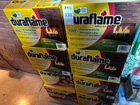 Stack of sealed Duraflame firelog cartons showing branding and quantity