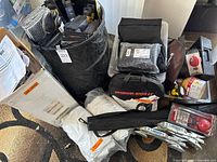 overview of lot showing sun shields, wipers, tire chains, car cover, tools