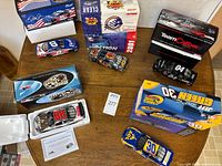 All five cars and boxes on table