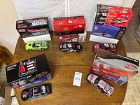 Overview of five die-cast cars and their boxes on table