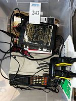 Overall view of lot showing stacked radios, wiring and yellow handhelds