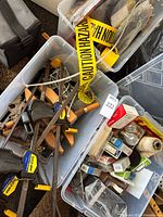 Overview of three bins with clamps, tie-downs, hazard tape, twine and electrical items