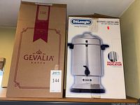 Gevalia and DeLonghi product boxes on shelf
