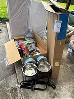boxed collapsible crate with assorted bowls, leads, toys