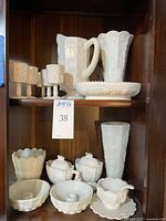 Shelf with pitcher, basin, candlesticks, cups