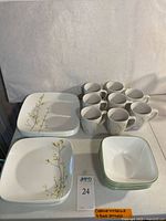 Full view of stacked dinnerware and mugs