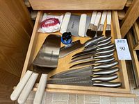 Drawer view showing spreaders, scrapers, knife set and sharpener