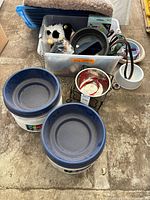 Lot overview showing plastic feeders, raised bowl stand, bin of toys and accessories