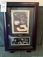 Full view of framed shadow box showing photo and model car