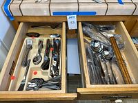 Open drawer with organized flatware and sleeved pieces visible