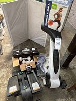 Group shot showing SitNcycle, stepper, stability ball box, dumbbells box, resistance band