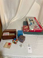 Overall lot showing board games, puzzles, card box, Rubik's Cube, dice