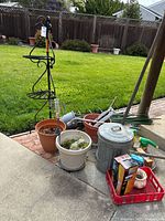 Group shot of entire lot showing plant stand, pots, mulch can, tools, stakes and accessories