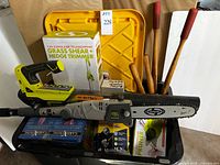 Overview of bin with Sun Joe power tools, Ryobi blower, wood-handled tools