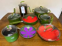 Group shot of all green Cook's Essentials cookware, Kuhn Rikon pot, lids, silicone protectors