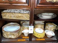 Dinnerware stored in padded cases showing multiple stacks of plates, cups, serving pieces