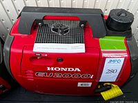 Left side view showing Honda EU2000i graphics and recall tag