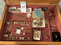 Drawer view showing full assortment of cufflinks, pins, earrings, chains