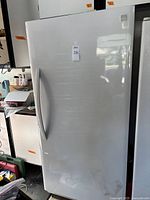 Front view of white upright freezer with handle