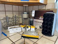 Overall lot showing brewer, frother, drawer box, vertical holder, carousels, filter boxes, reusable filter boxes, trivet