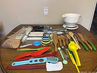 Full lot overview on table showing scale, wooden utensils, scrapers and various tools
