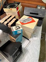Stack of Kodak slide trays, viewers’ boxes, carrying case