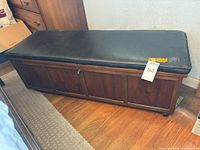 Front and side view of cedar chest on floor