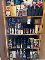 Full cabinet view showing four shelves packed with AMSOIL fluids and filters