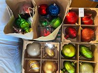 Overview of two paper bags and two boxes containing large assorted ornaments
