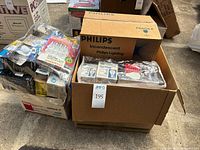 Overall lot showing Philips box of flood bulbs and additional packaged bulbs