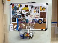 Board displaying magnets and accessories bag attached