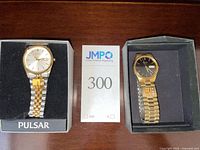 Both watches in boxes side by side