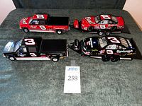 Top view showing both model truck and car pairs with trailer and race cars