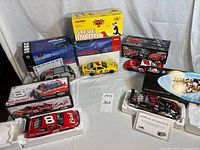 Group shot showing all five boxed die-cast vehicles, two opened in foam inserts