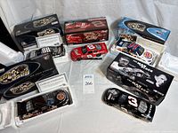 Overall lot showing six boxed 1:24 die-cast cars, two loose cars and COAs