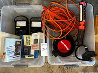 Overview of all items in totes: multimeters, boxes, Snap-On cord reel, work light, cords