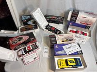 Group view of five boxed die-cast NASCAR cars with COAs visible
