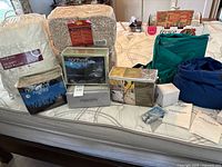 Group shot of all packaged bedding and inflatable beds on mattress